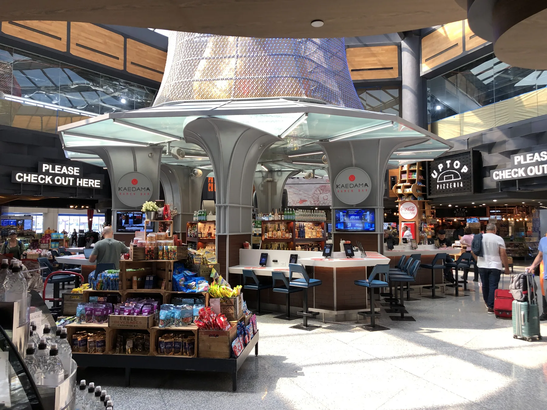 Shared seating and restaurant counters inside Newark Liberty International Airport Terminal C